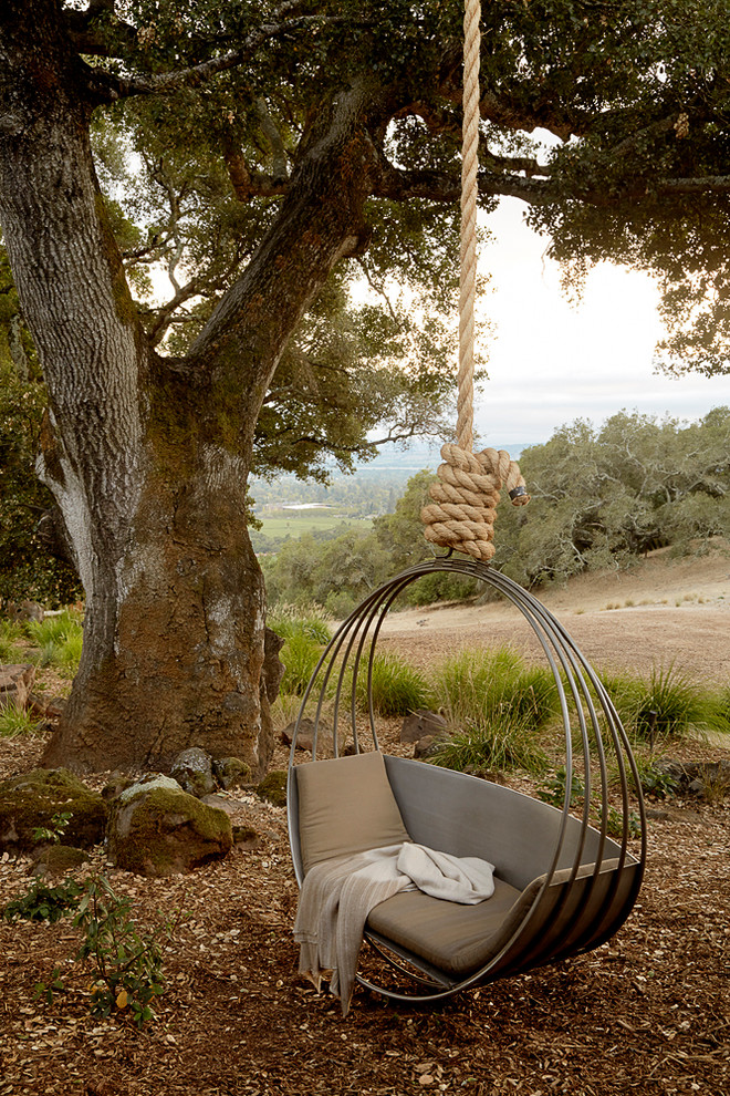 La balançoire suspendue, dont l'assise est constituée d'anneaux métalliques, deviendra une véritable décoration de votre jardin